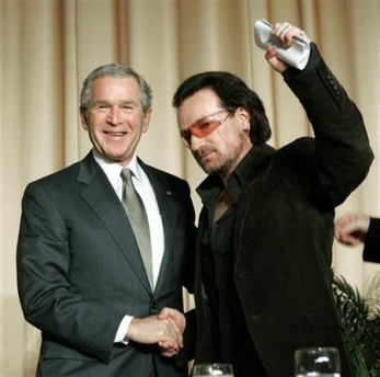 President Bush and political activist and entertainer Bono, right, shake hands after Bono spoke at the National Prayer Breakfast, Thursday, Feb. 2, 2006, in Washington.